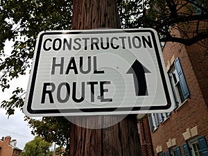 Construction haul route sign with arrow on post