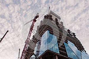 Construction of high-rise building. Construction cranes and skyscraper