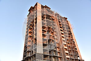 Construction the high-rise building. New residential skyscraper on blue sky background.  Tall house renovation project, government