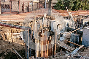 Construction of a high-rise building. Pouring of foundation columns with concrete