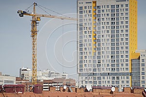 Construction of a high-rise building. Tower crane.