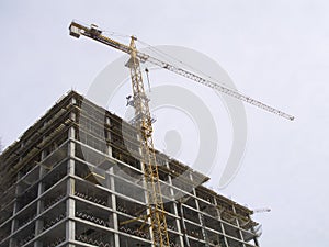 Construction hoisting crane above building house