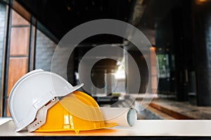 Construction house and building. Repair work. Drawings for building and helmet on white table