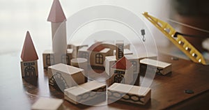Construction of houses from wooden blocks. Toy playful buildings, top view