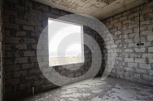 Construction of an individual residential building, wall view with a square large window opening