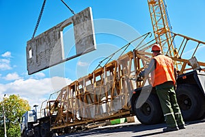 Construction industrial worker operating hoisting process of concrete slab
