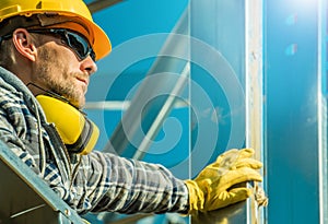 Construction Industry Contractor Worker Staying Next to Aluminium Building Frame