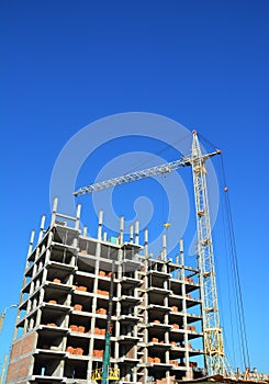 Construction industry with Crane, Copy Space, Sky Background. Crane Building New House on the Construction Site.