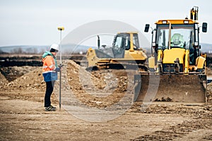 Construction industry details with surveyor using GPS system and total station. Engineer and geodesy