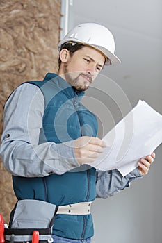 construction industry engineer eading paper plans photo