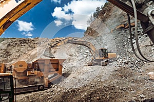 construction industry - Heavy duty Track type excavator loading granite rock
