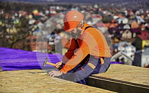 Construction Industry and Waterproofing. roofer working on roof structure of building on construction site. roofer wear