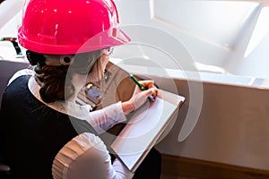 Construction inspector woman takes notes
