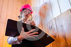 Construction inspector woman takes notes