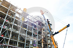 Construction and installation work with a powerful construction crane of a large new industrial oil refining petrochemical