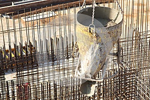 Construction of a large commercial building. Cement supply on the background of a construction site with associated armature.