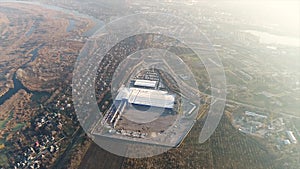 Construction of a large factory, industrial exterior, panoramic view from the air. Construction site, metal structure