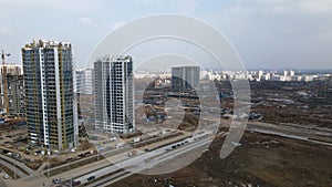 Construction of a large residential area. The construction site is visible. Multi-storey buildings and infrastructure under constr