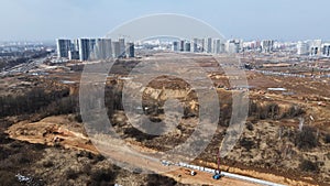 Construction of a large residential area. The construction site is visible. Multi-storey buildings and infrastructure under constr