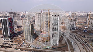 Construction of a large residential area. The construction site is visible. Multi-storey buildings and infrastructure under constr