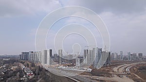 Construction of a large residential area. The construction site is visible. Multi-storey buildings and infrastructure under constr