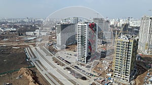 Construction of a large residential area. The construction site is visible. Multi-storey buildings and infrastructure under constr