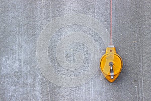 The construction level is yellow. Concrete wall. Tools for building a house.