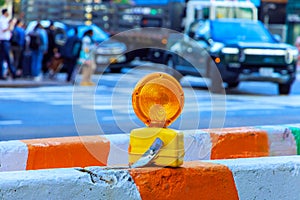 Construction light on barricade is intended to warn construction workers of presence at construction site.