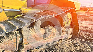 Construction machinery. Caterpillar part of construction equipment close-up closeup of yellow Caterpillar bulldozer with the lift