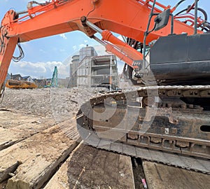 Construction machinery at the construction site is engaged in the dismantling of buildings. A demolished