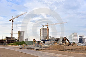 Construction machinery and Equipment on road work. Excavator and tractor on earthmoving at construction site. Tower cranes in