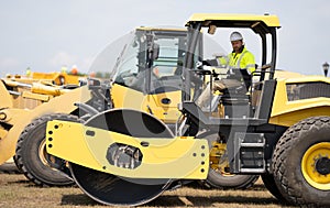 construction machinery worker. machinery in a manufacturing industry with construction worker outdoor. construction