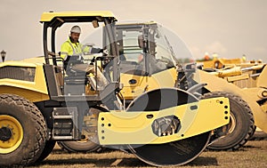 construction machinery worker. machinery in a manufacturing industry with construction worker outdoor. construction