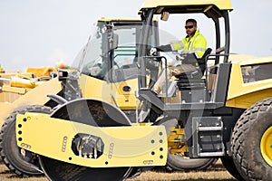 construction machinery worker at roller. machinery in a manufacturing industry with construction worker outdoor