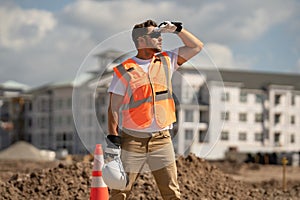 Construction man with helmet. Worker at construction new building. Builder at construction site. Foreman workman