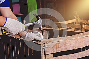 Construction man workers in blue shirt with Protective gloves working with hammer