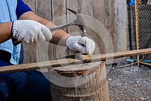 Construction man workers in blue shirt with Protective gloves working with hammer