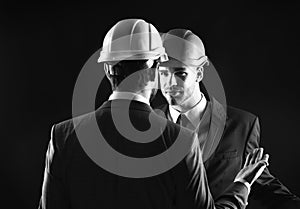 Construction management concept. Engineers isolated on black background.