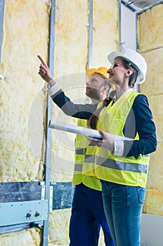 Construction manager and architect checking the insulation works