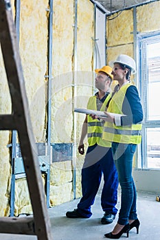 Construction manager and architect checking the insulation works