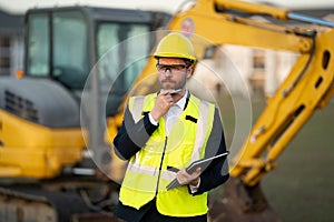 Construction manager in suit and helmet at a construction site. Construction manager worker or supervisor wearing