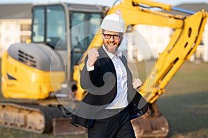 Construction manager in suit and helmet at a construction site. Construction manager worker or supervisor wearing