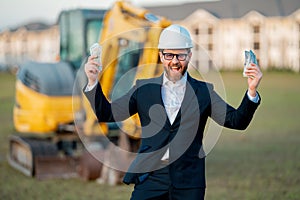 Construction manager in suit and helmet at a construction site. Construction manager worker or supervisor wearing