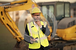 Construction manager in suit and helmet at a construction site. Construction manager worker or supervisor wearing