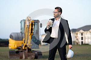 Construction manager in suit and helmet at a construction site. Construction manager worker or supervisor wearing