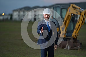 Construction manager in suit and helmet at a construction site. Construction manager worker or supervisor wearing