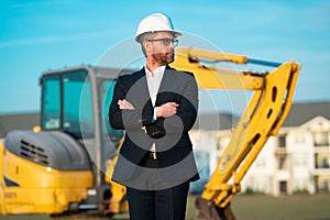 Construction manager in suit and helmet at a construction site. Construction manager worker or supervisor wearing