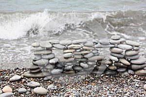 Construction of many pebbles on a sea coast