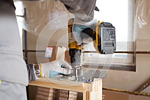 Construction mason worker attach the window metal fitting to skylight.