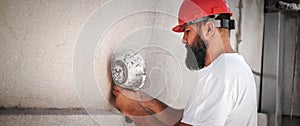 Construction mason worker plastering old building wall using cement plaster mix